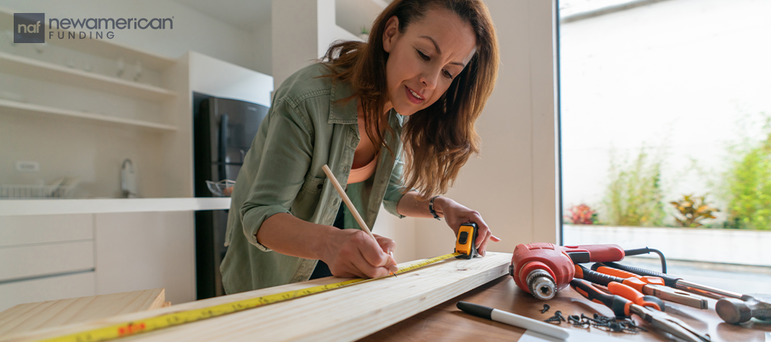 A woman drawing plans on a table.
