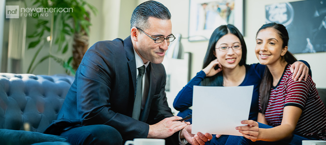 A lesbian couple meeting with a loan officer.