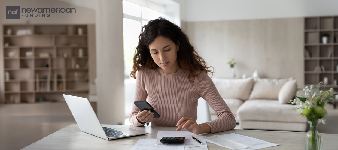 A woman calculating her bills.