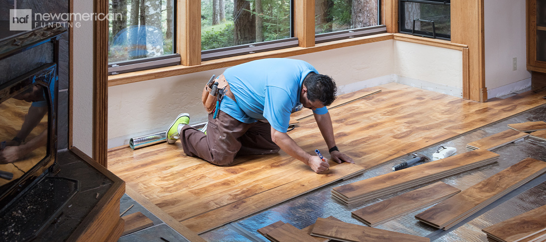 A man installing new flooring in a home.