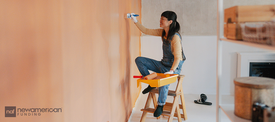 A woman painting a room.