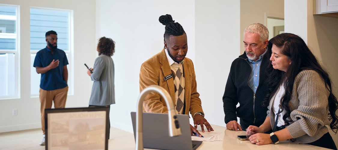Real estate agent talking to couple during an open house