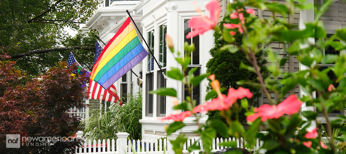 A rainbow flag flying on a house.