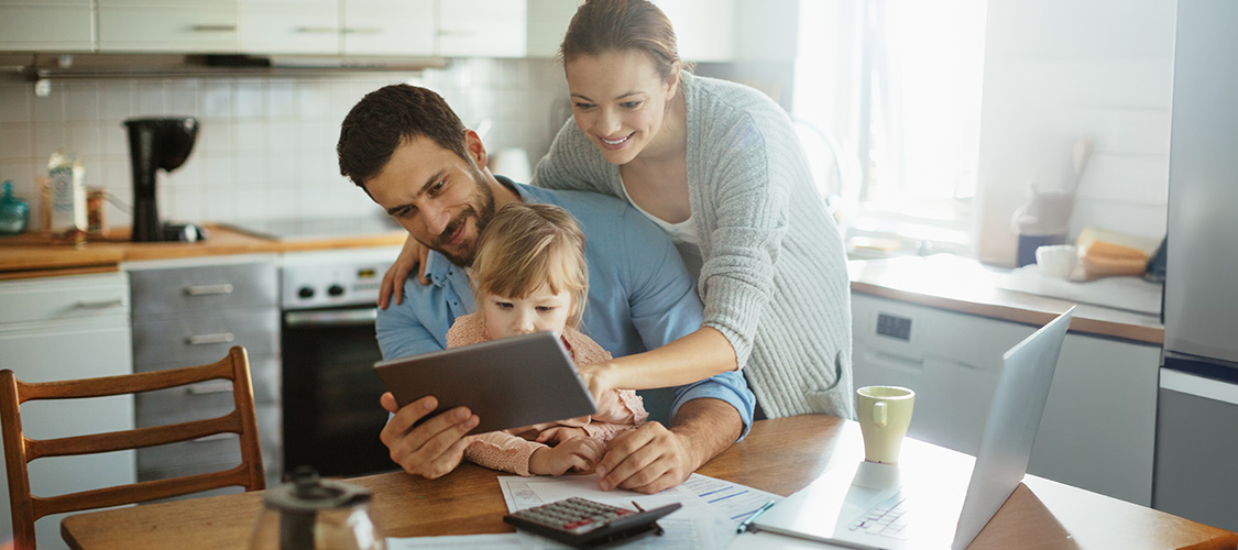 Family reviewing finances on a tablet