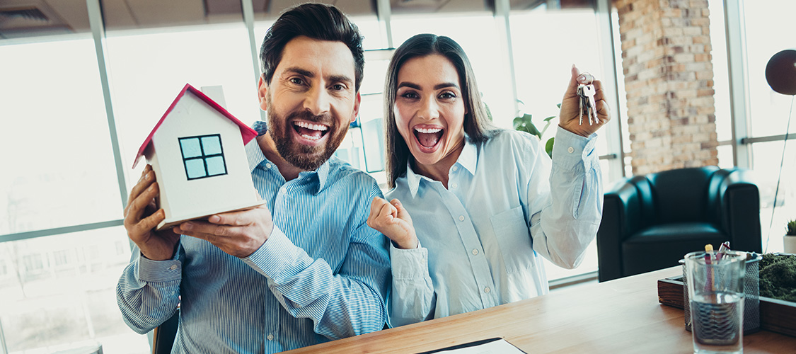 A happy couple celebrating buying a home