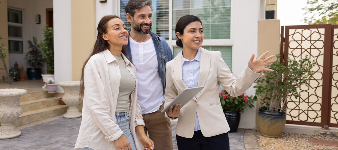 A couple discussing a home with a real estate agent