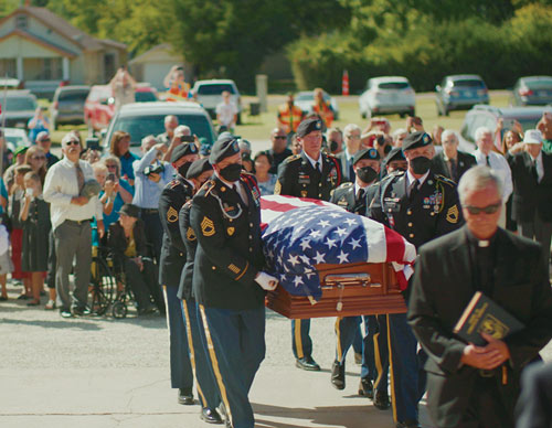 Soldiers from the U.S. Army&rsquo;s 1st Cavalry Division carry the remains of Father Emil Kapaun into St. John Nepomucene Church