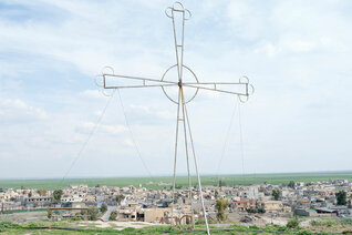 Father Thabet Habib Yousif views the damage to his parish