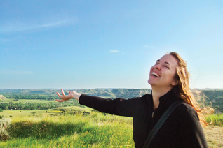 Michelle Duppong gestures joyfully to the beauty of the North Dakota Badlands during a visit to Theodore Roosevelt National Park around 2013. (Courtesy of the Duppong family)