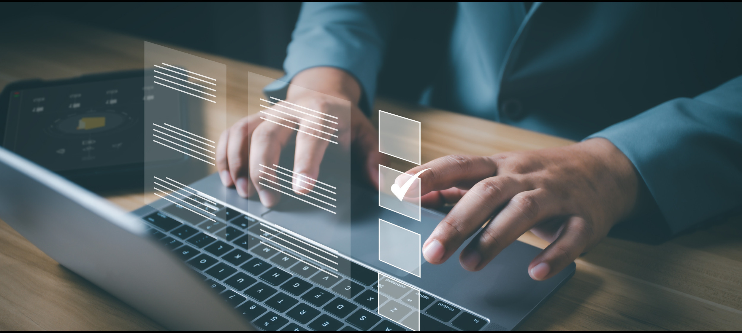 Close-up of man typing on a laptop, graphic of form fields is overlaid 