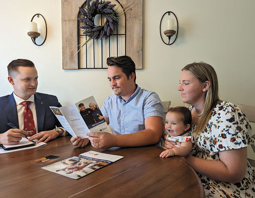 David St. Hilaire, a field agent with the Swanson Agency in Hastings, Neb., visits with a K of C family about their insurance needs.