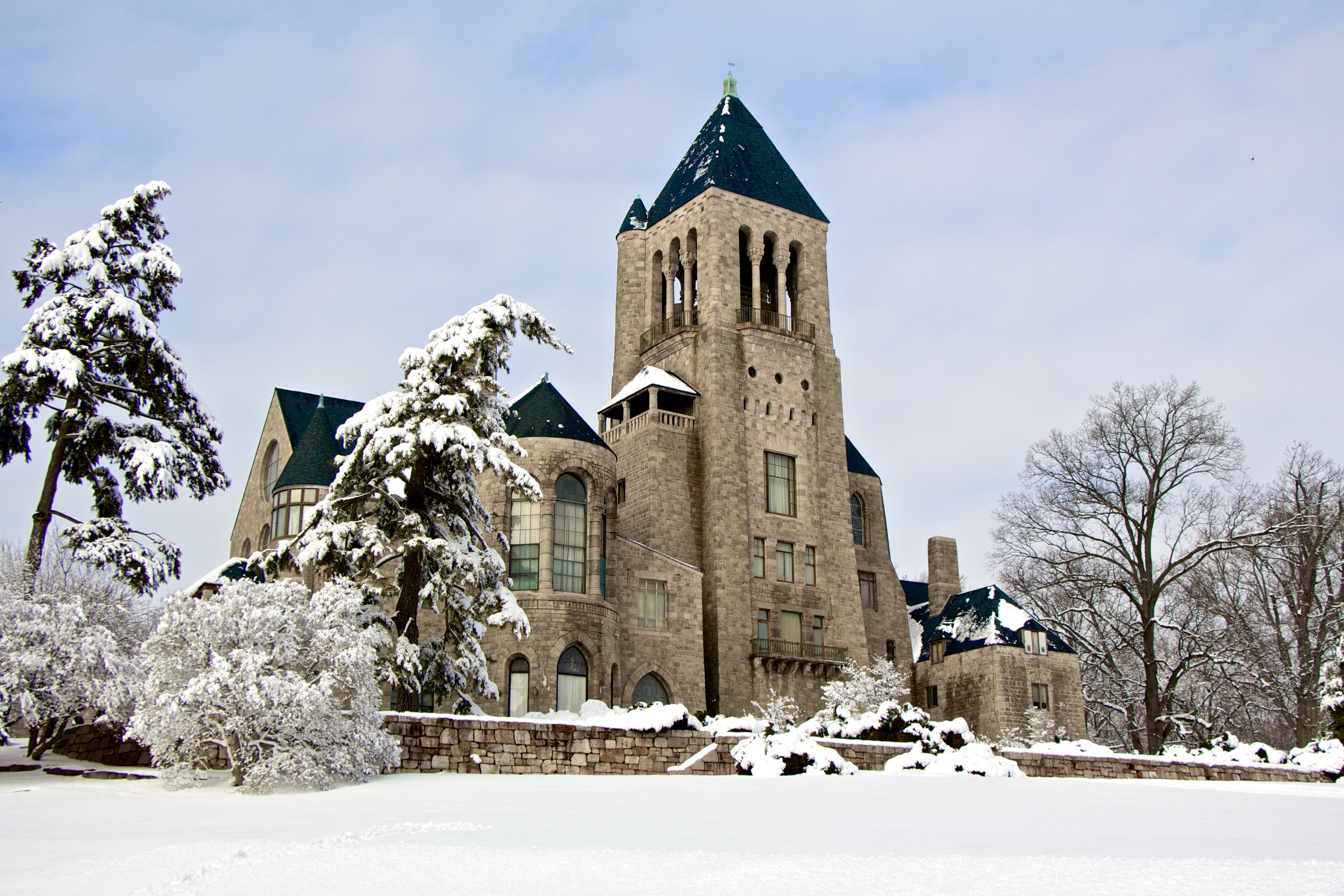 Snow covered exterior of Glencairn Museum, a castle-like structure, and its grounds, Bryn Athyn, PA. 