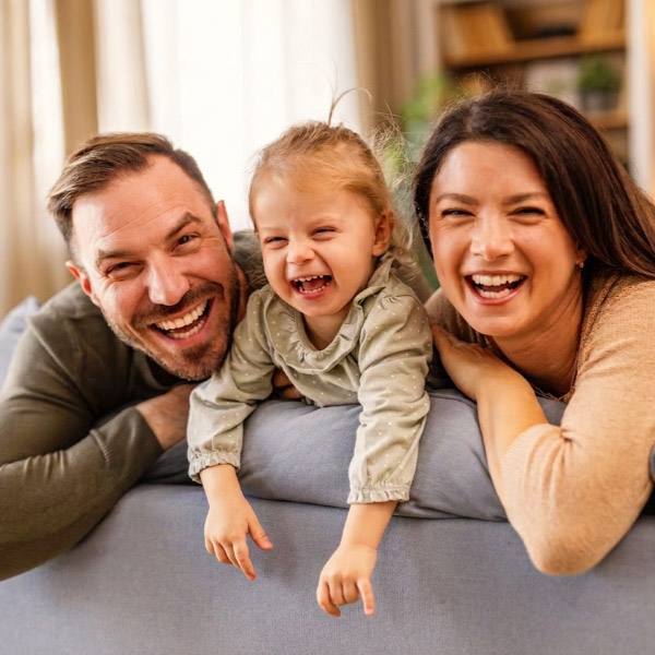 happy family on the couch laughing together