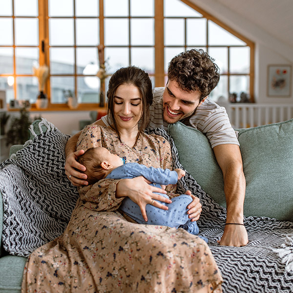 young family with newborn in their living room