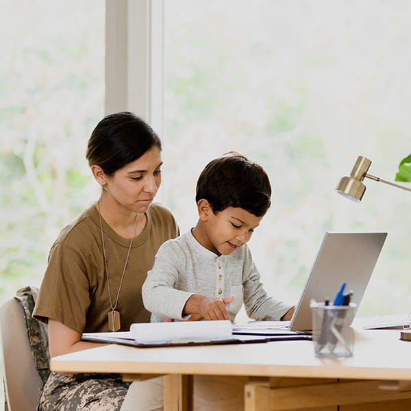military mom with her son in front a laptop