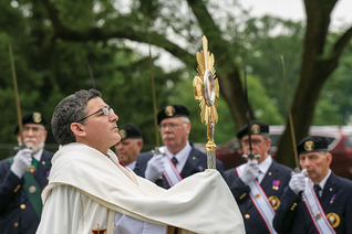 Father Andrés Ayala raises the Eucharist in benediction during National Eucharistic Pilgrimage events at the National Shrine of St. Elizabeth Ann Seton in Emmitsburg, Md., June 6.