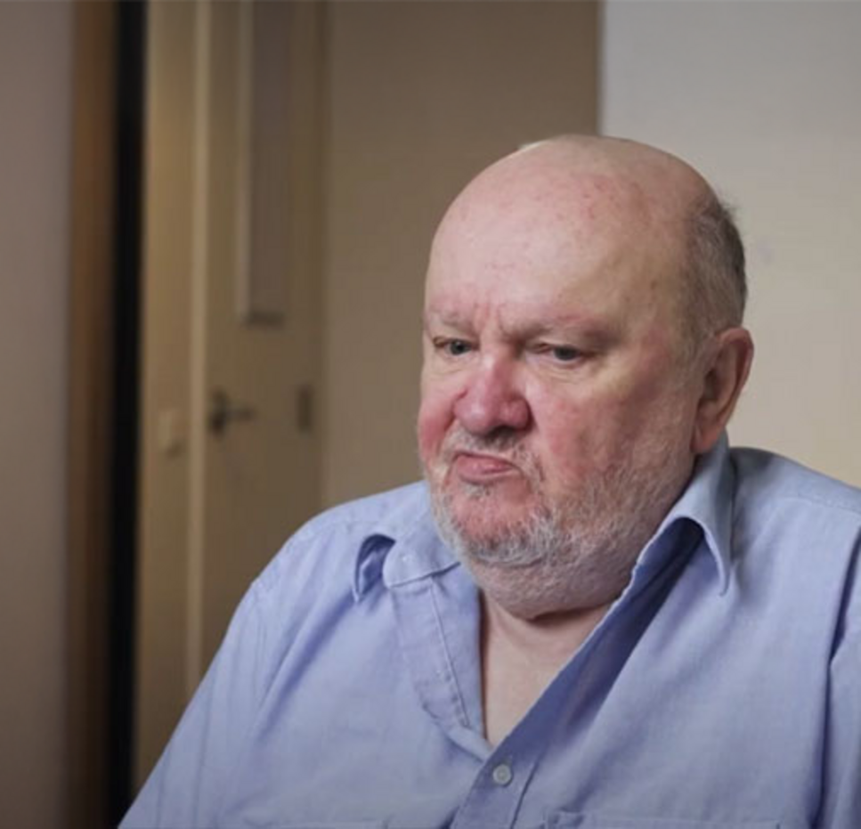 Portrait of Miles, a Mission Australia client, sitting indoors, featured in the Summer 2025 Impact Report