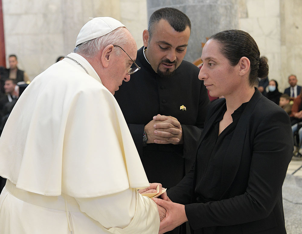 Doha Sabah Abdallah, whose son was one of the first ISIS casualties in Qaraqosh, speaks with the pope through an interpreter after giving her testimony.