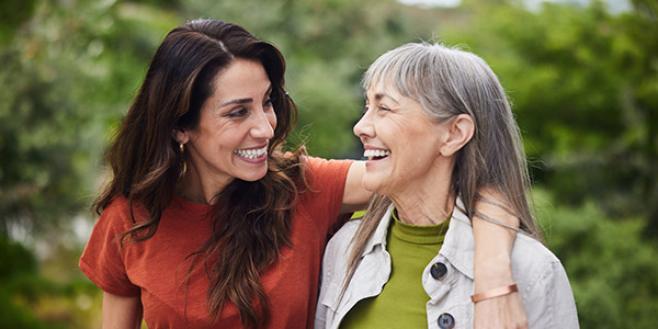 mother and daughter smiling and hugging each other