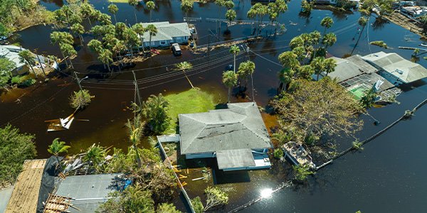 An overhead view of a flooded neighborhood where only the roofs are visible