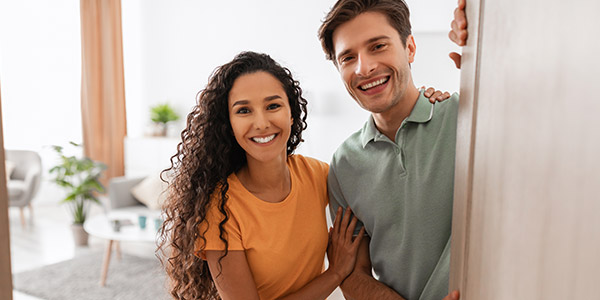 couple opening the door to their new home