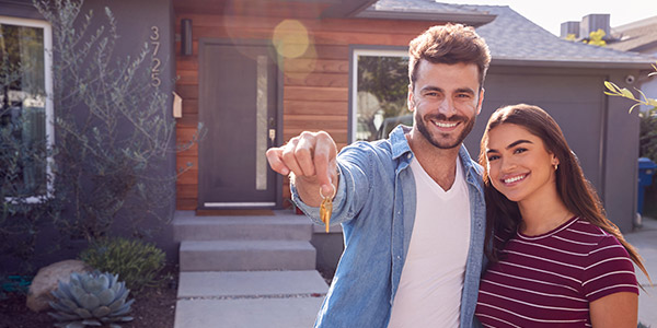 couple showing off their new house keys