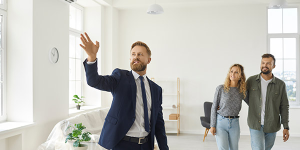 real estate agent showing a house to homebuyers