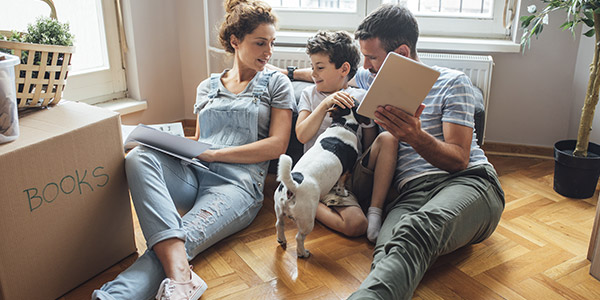 family sitting on the floor with their dog