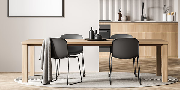 Modern dining room and kitchen with a wooden kitchen table with four black chairs