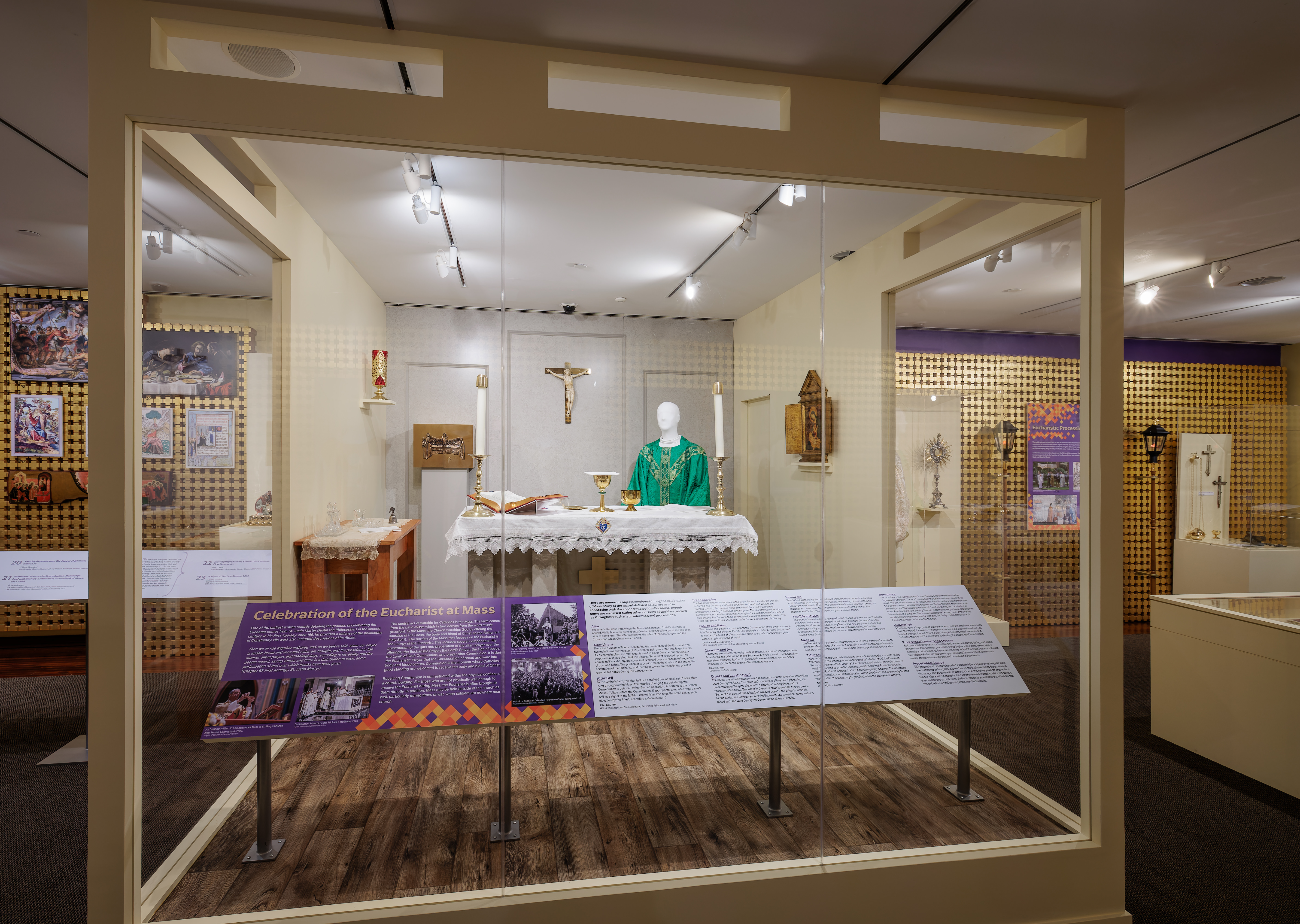 Photo of the temporary exhibit "True Presence: The Eucharist in History and Art." Depicts case with setup of altar during  Mass.