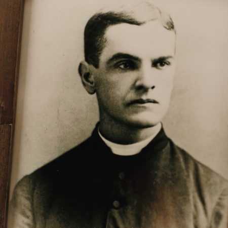 Closeup portrait of Father McGivney in a wood frame.