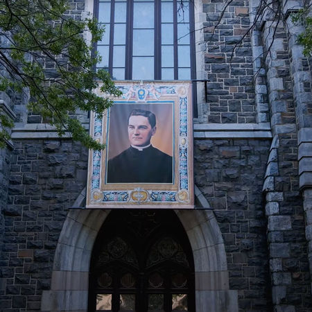 Front entrance of St. Mary's Church in New Haven, Connecticut displaying a banner of Father McGivney for its first patronal feast day.