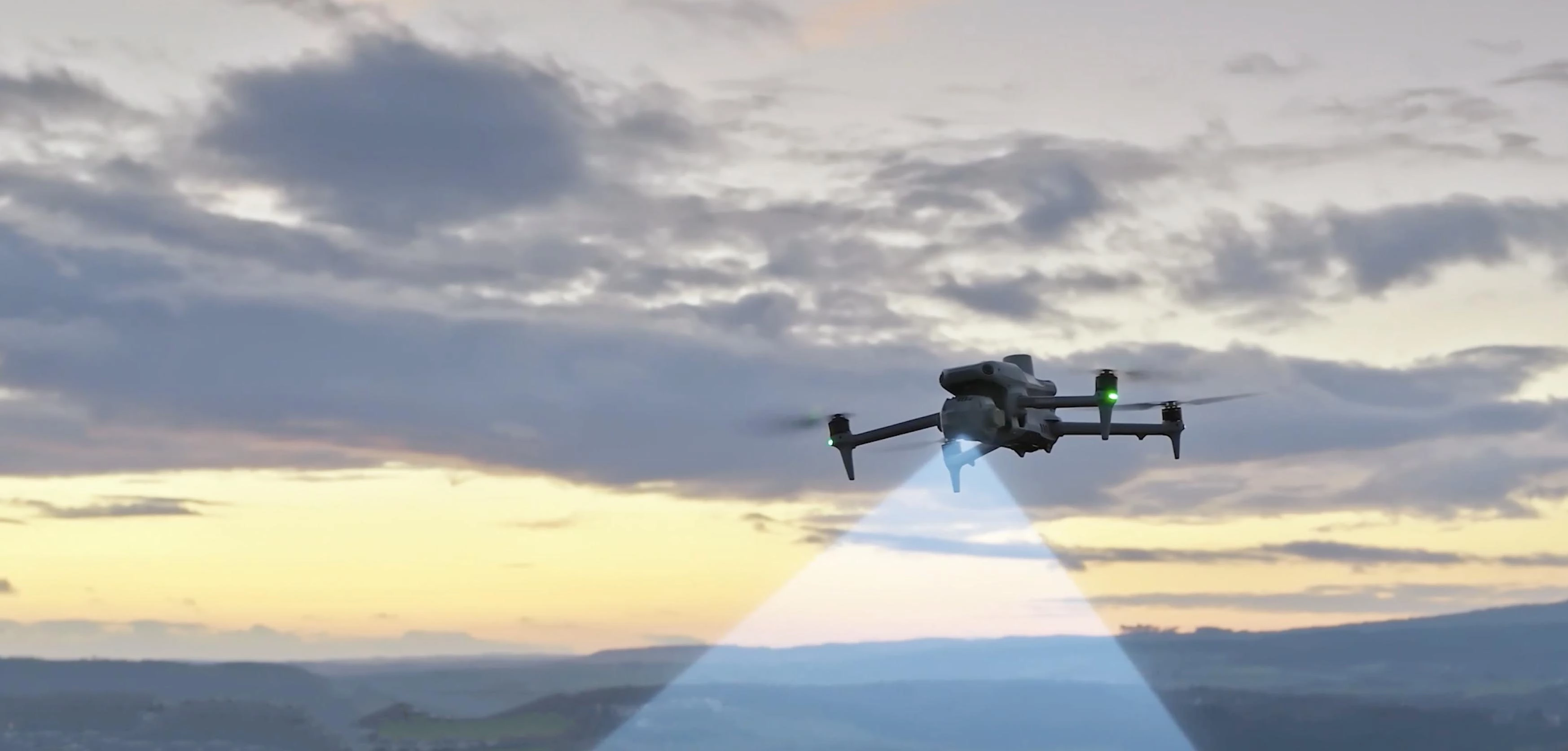 DJI Matrice 4E drone in flight against a dramatic sunset. 