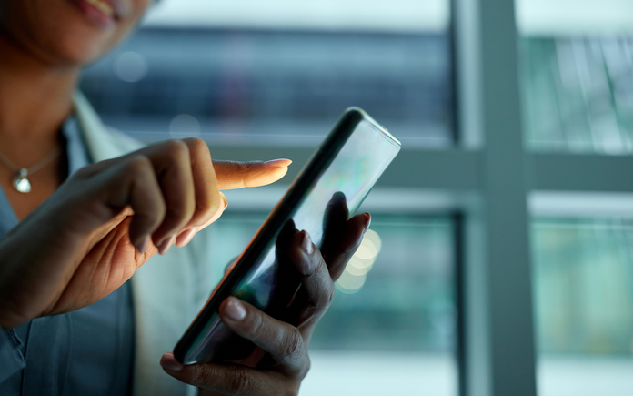 Man Using Smartphone with copper beryllium connectors and springs to enable greater capabilities